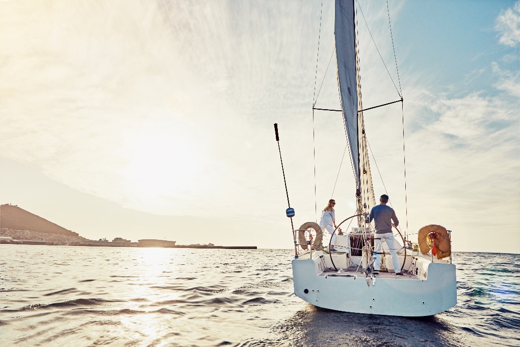 A couple sailing a yacht in the ocean 